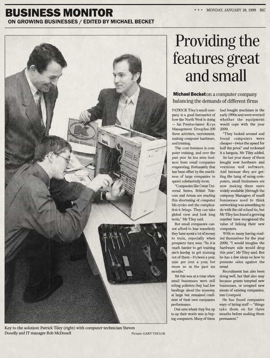 Newspaper clipping from January 1999: Business Monitor feature on Patrick Tiley's training business, with a photograph of Patrick and colleagues examining a computer